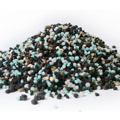 Curb appeal premium lawn fertilizer mini prills in a pile showing the different ingredients and components such as the compost and biochar 