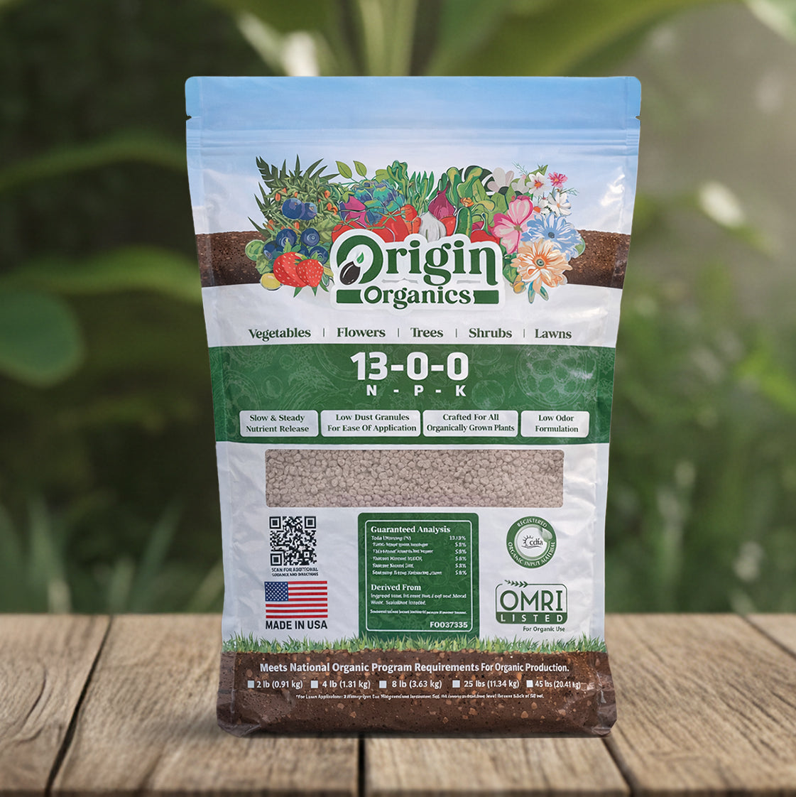 Origin Organics fertilizer package on a wooden surface with a blurred green background